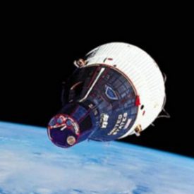 1960s spacecraft, traveling above earth, has specialized heat-resistent widows