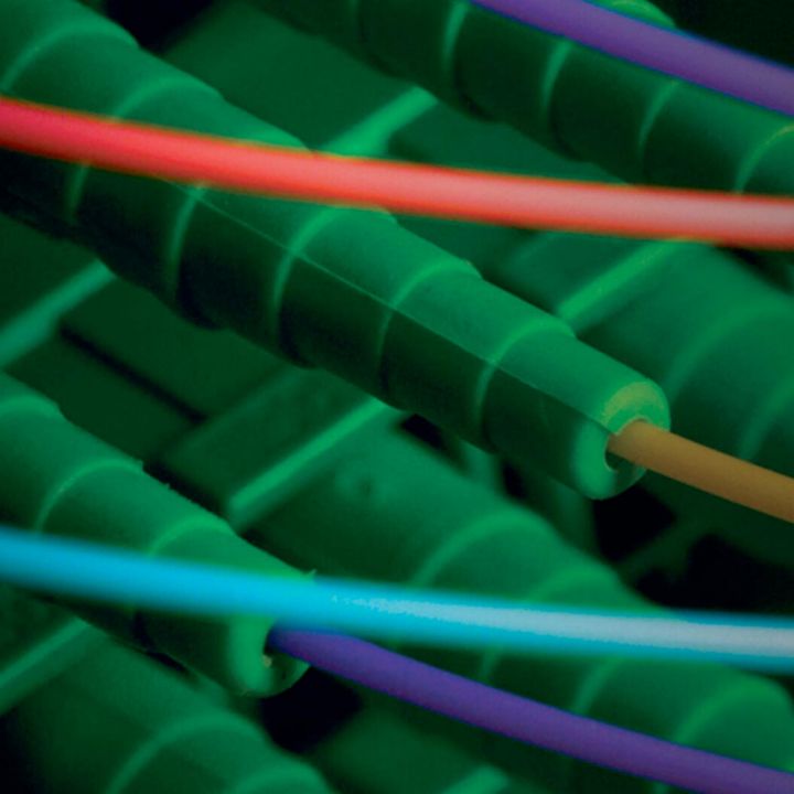 Extreme closeup of multicolored fibers attached to green housings