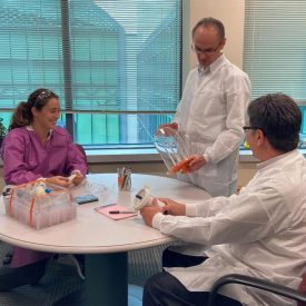 3 R&D team members sitting at a table conversing