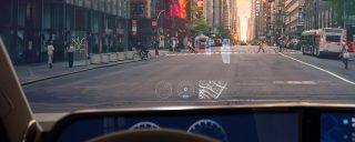 Image of a car driving on a city street.