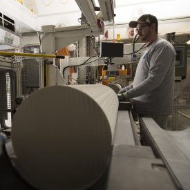 Man working on cordierite log