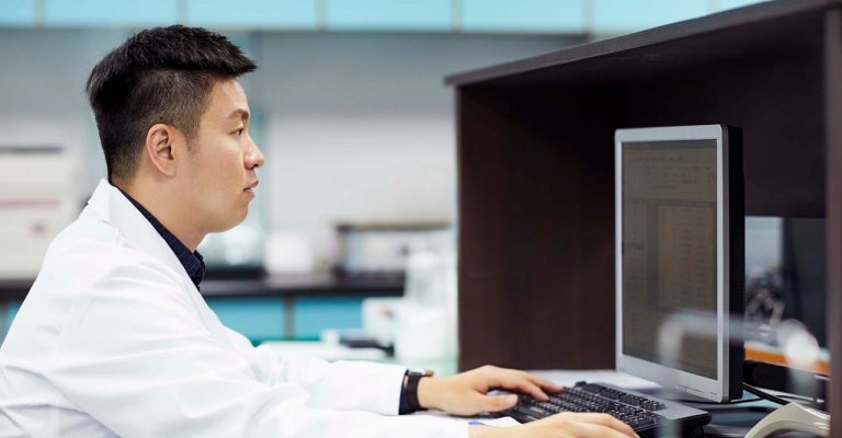 Scientist typing on computer