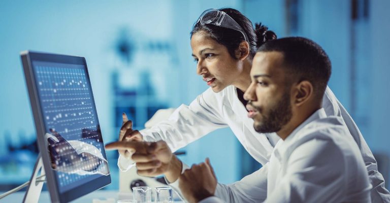 Scientists working on a computer