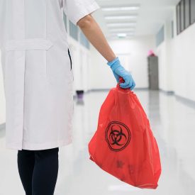 Scientist holding bag of waste from lab