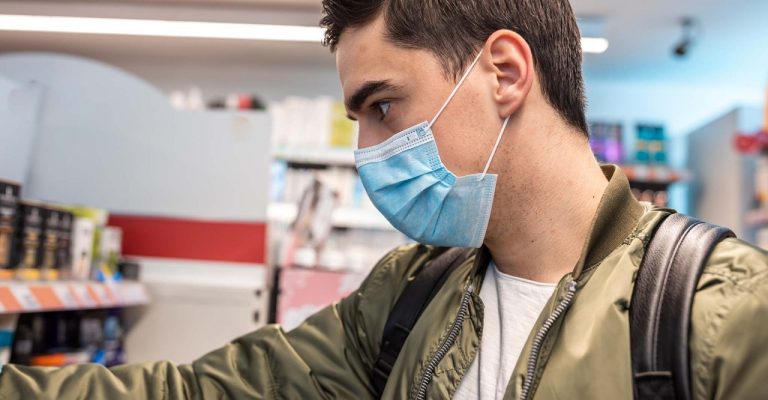 Man shopping in grocery store with a mask