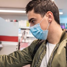 Man shopping in grocery store with a mask