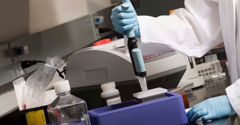 Scientist working with liquid pipettor and coolbox