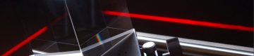 Bright red laser beam shoots through optic component