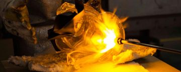 Closeup of metal, glass being forged in fire