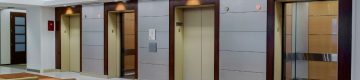 Four SnapCab® elevators share wall in lobby setting