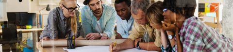 Close-up six people around drafting table