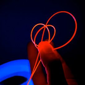 Person holds glow red loops of Fibrance Light-Diffusing Fiber