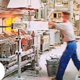 Man loads glass material into a machine