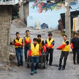 Corning employees maneuver bin of coal in Seoul, Korea