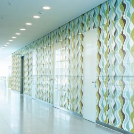 Hallway walls covered in glass embedded with wavy vertical pattern