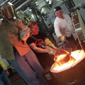American sculptor Albert Paley guides others during materials forging process
