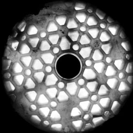 Large, round lens has rugged, honeycomb-like pattern