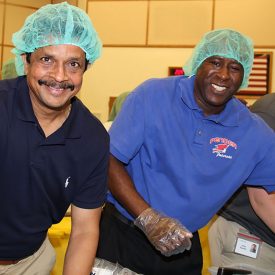 Corning employees seal some of the 10,000 meals prepared