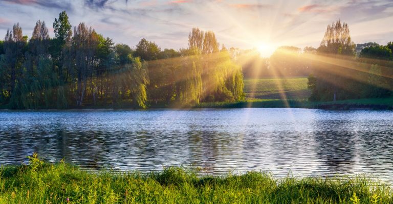 Sun shining over lake