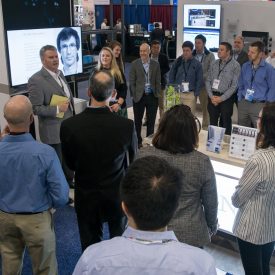 People gathered in Corning's OFC booth