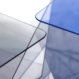Closeup of rounded corners of clear glass, blue glass sheets