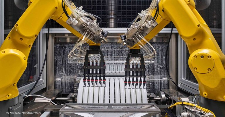 Yellow robot arms working on a Valor production line