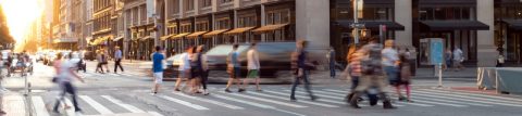 People walking across a city street