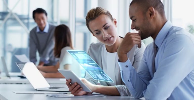 man and woman looking at iPad screen