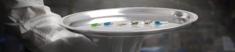 person holding plate of connectors and adapters