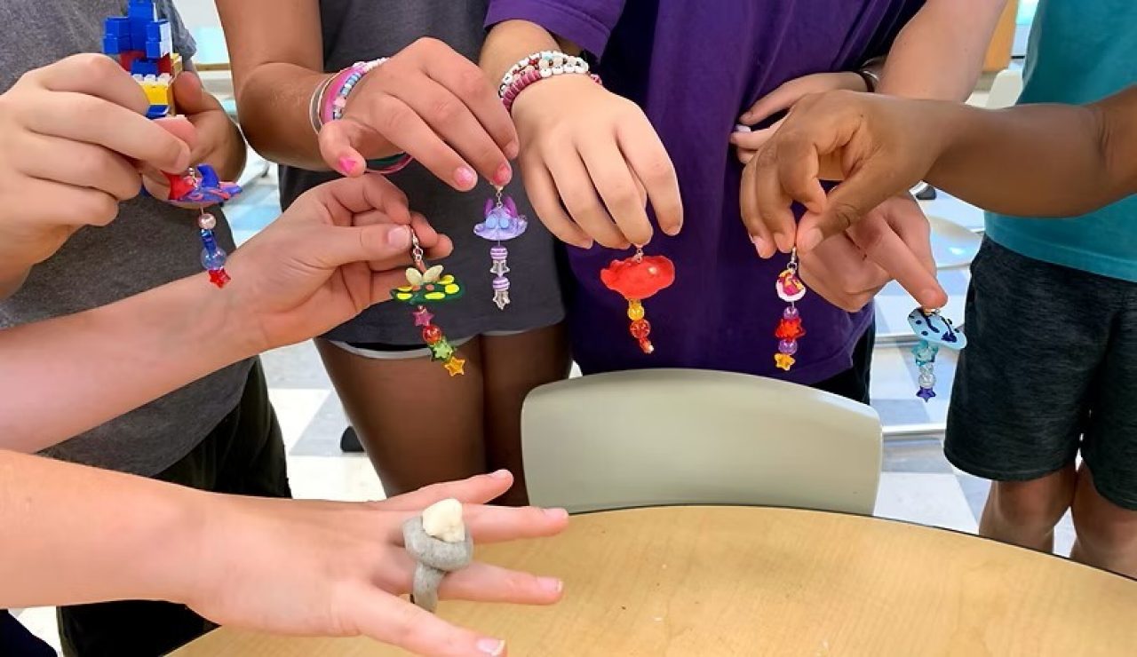 Children's hands holding clay keychains