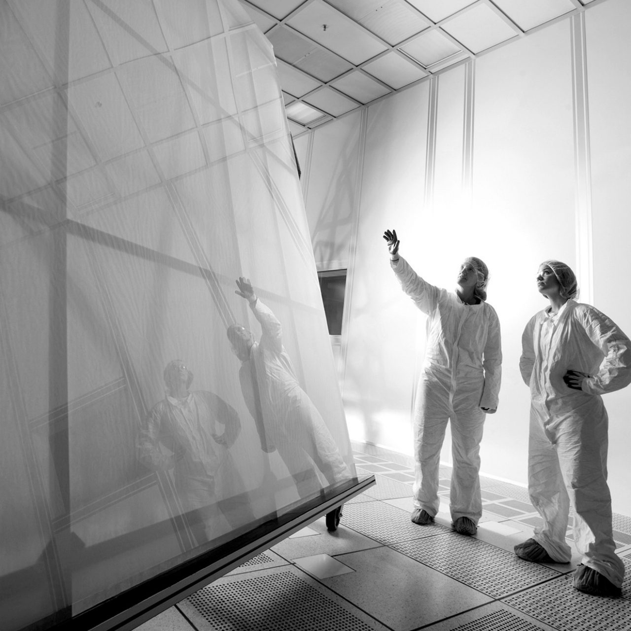 large sheet of glass and two scientists