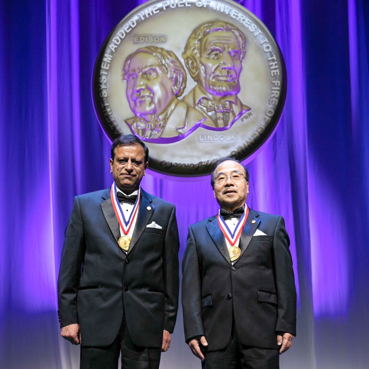 Pushkar Tandon, left, and Ming-Jun Li were inducted into the National Inventors Hall of Fame for their development of bendable optical fiber that brought high speed access to homes and data centers.