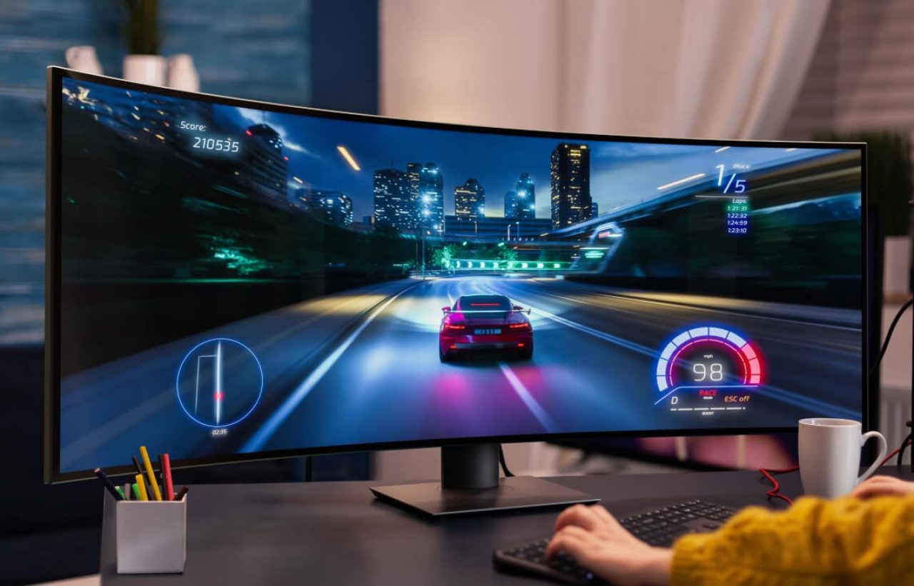 Studio shot of a premium gaming monitor displaying a car racing game