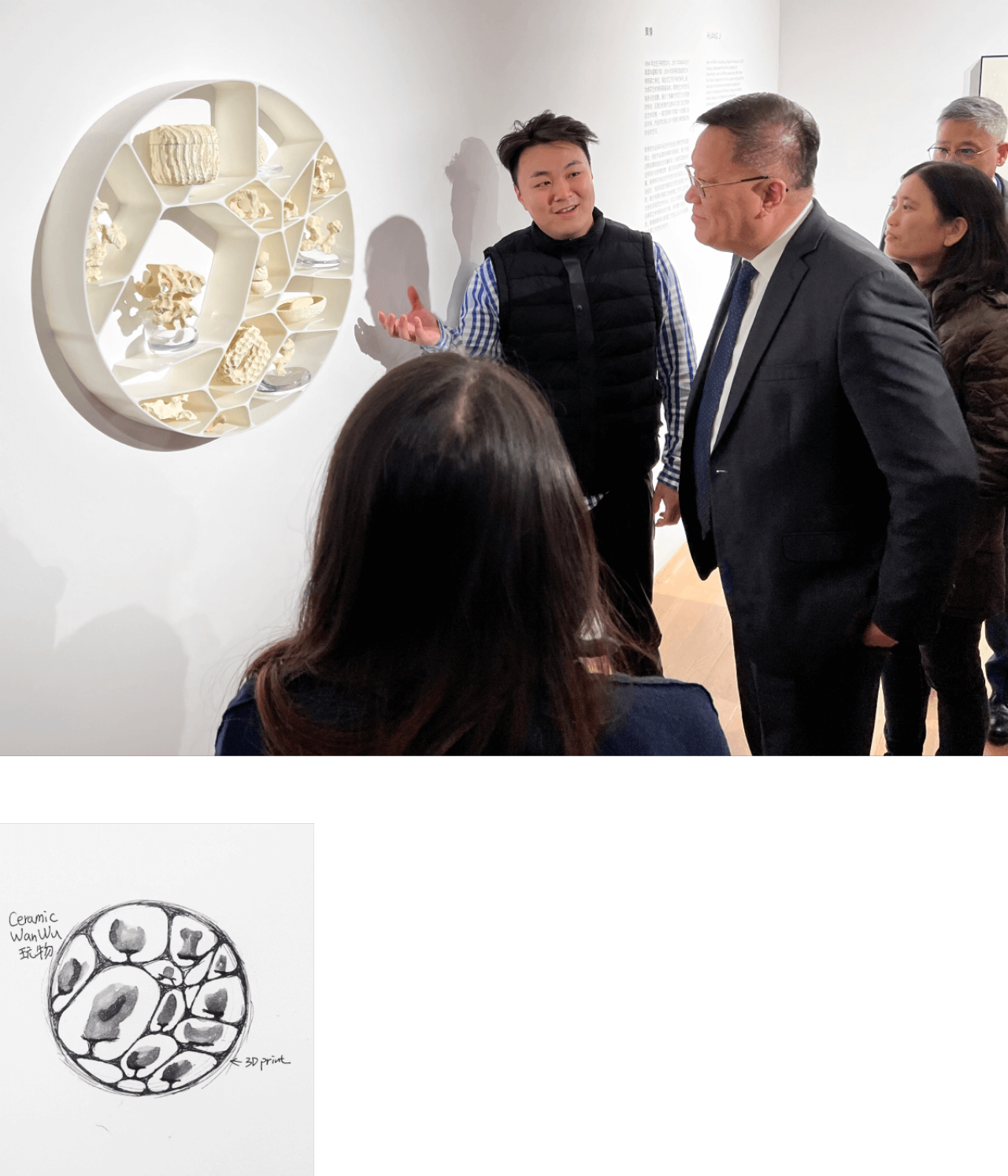 Ji Huang presents the piece which hangs on the gallery wall, to an onlooking group of visitors.