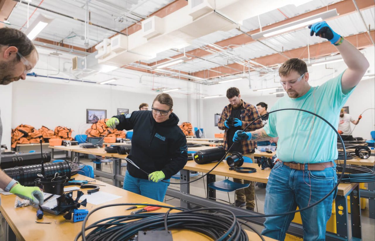 Participants in the fiber training program get hands-on experience working with optical cable.
