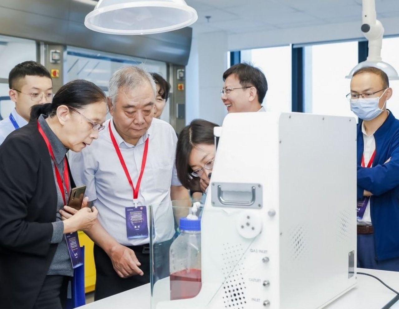 Experts from academia and industry check out an Advanced-Flow Reactor system at the AFR Academy’s opening in 2021.